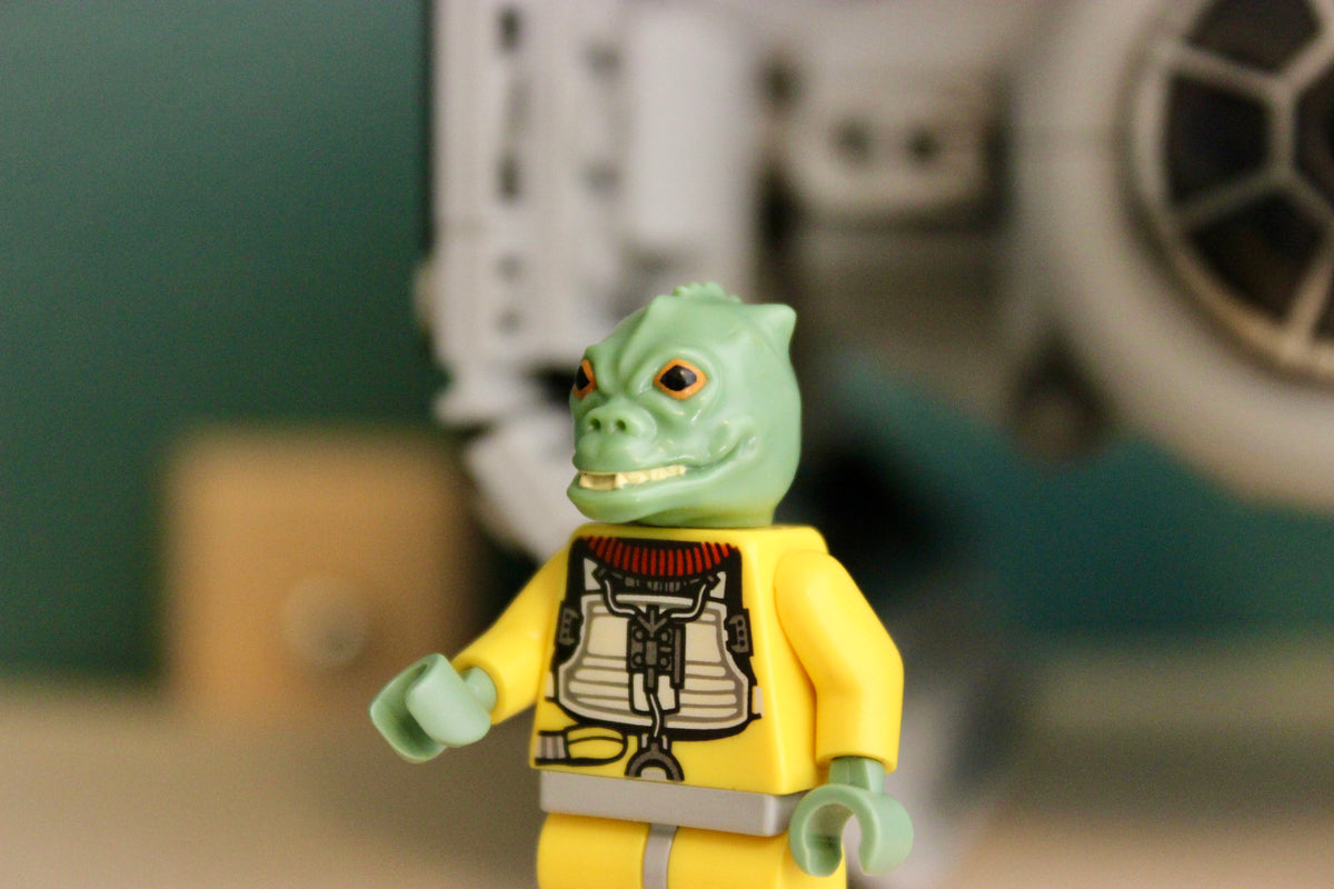 Bossk minifigure in front of the LEGO Slave I 8097