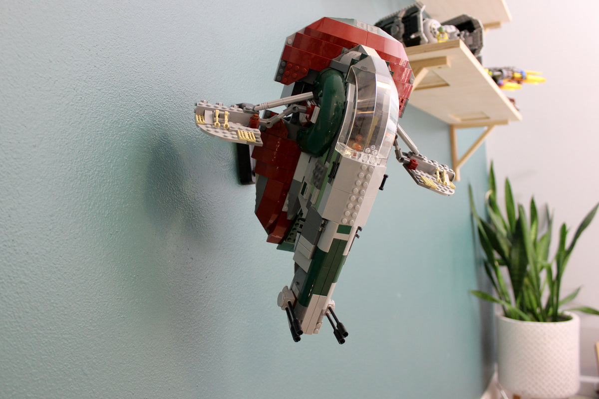 LEGO Slave I 8097 displayed on the wall above a potted plant