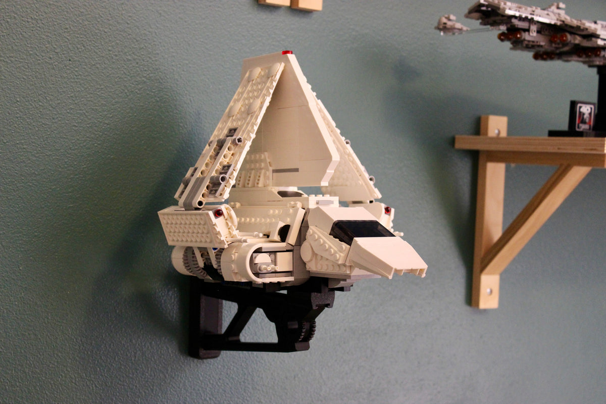 LEGO Imperial Lambda-Class Shuttle 75459 on the wall mount with its wings folded up, next to a wooden shelf