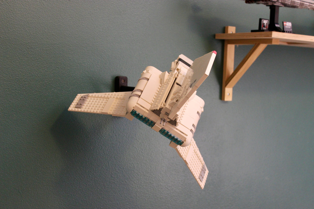LEGO Imperial Lambda-Class Shuttle 75459 angled on its wall mount below a wooden shelf