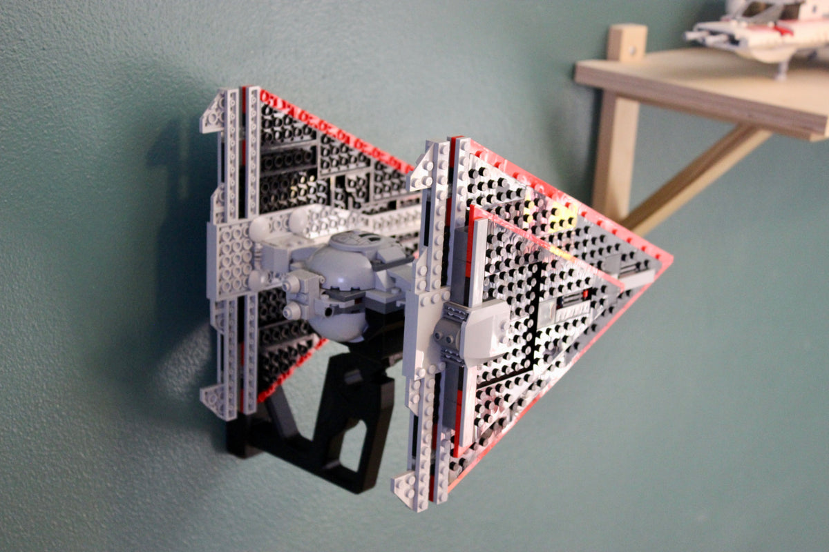 LEGO Sith TIE Fighter 75272 on the wall mount, side view, next to a wooden shelf