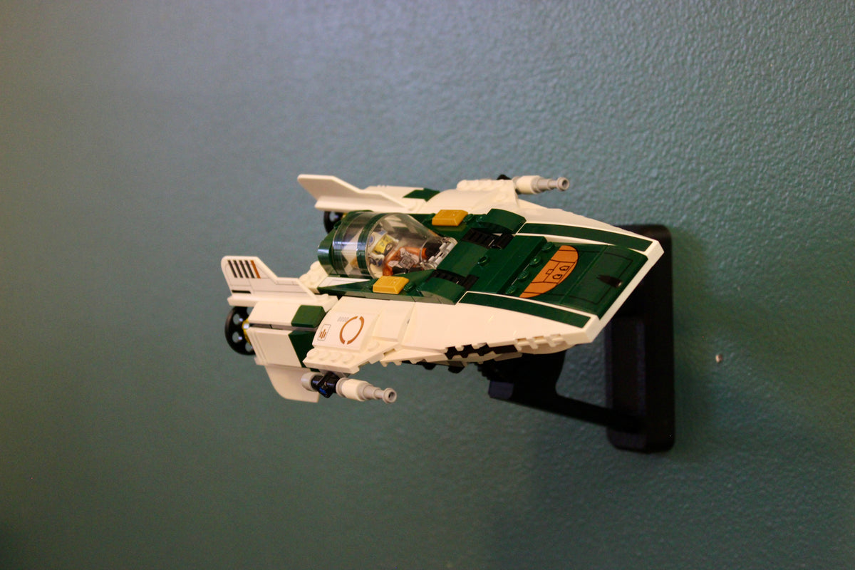 LEGO Star Wars Resistance A-Wing Starfighter 75248 on its black wall mount against a teal wall, side view
